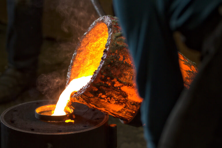 Molten bronze poured into mold by melter in foundry workshop - RT ...